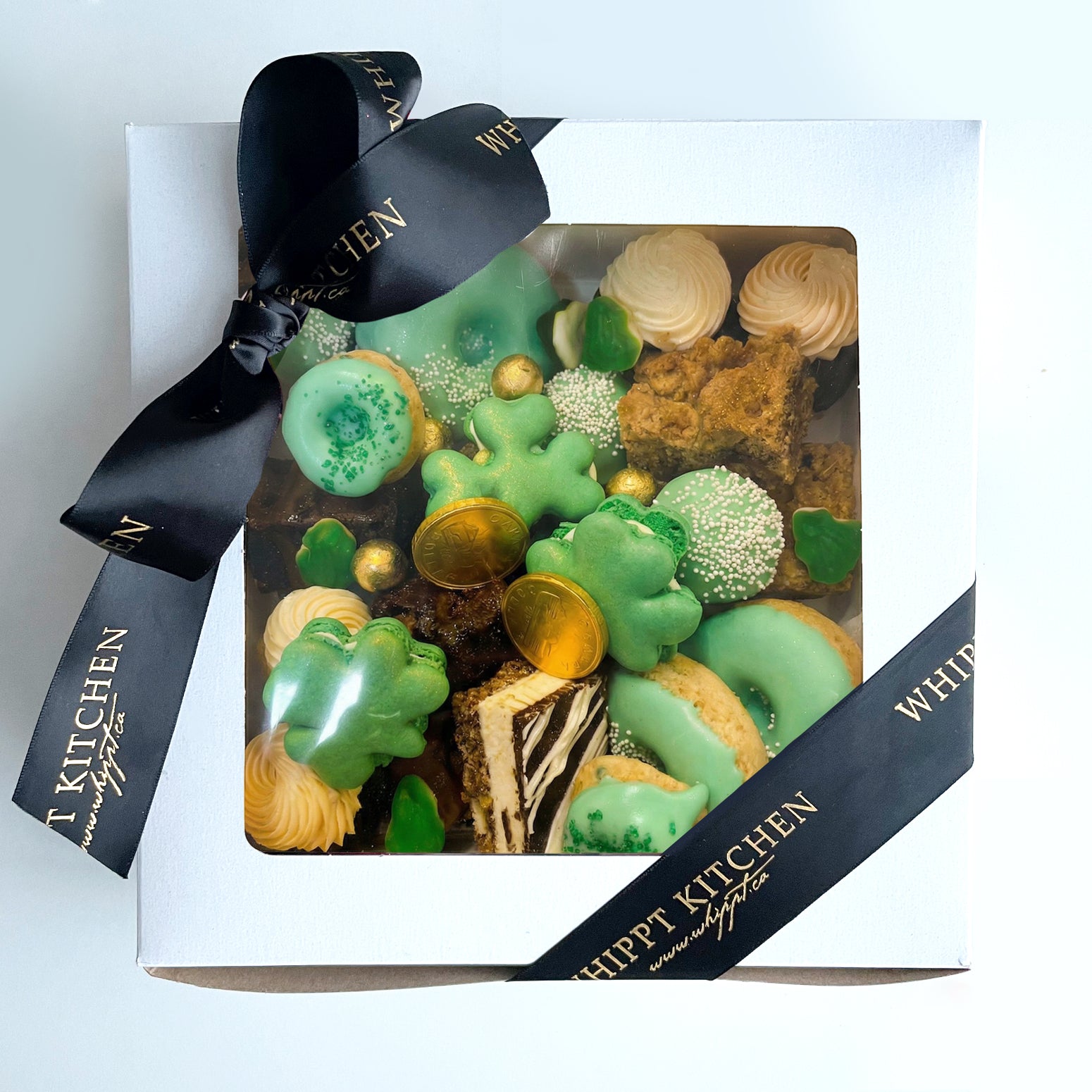 St Patrick’s Day mini dessert graze box filled with assorted bite sized sweets in festive green and gold colours from Whippt Kitchen Calgary